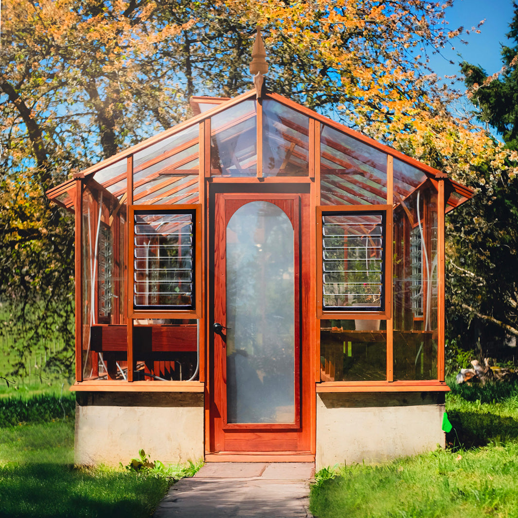 Wooden greenhouse with glass panels in a garden setting